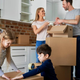 Family packing up boxes in a kitchen